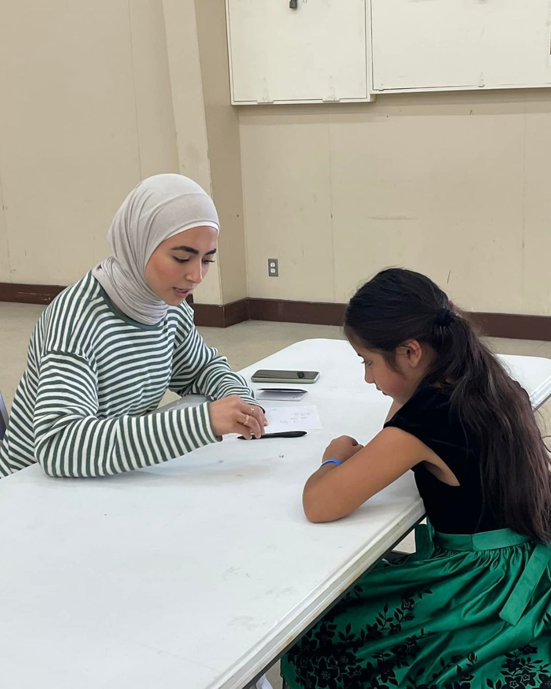 Women tutoring a child
