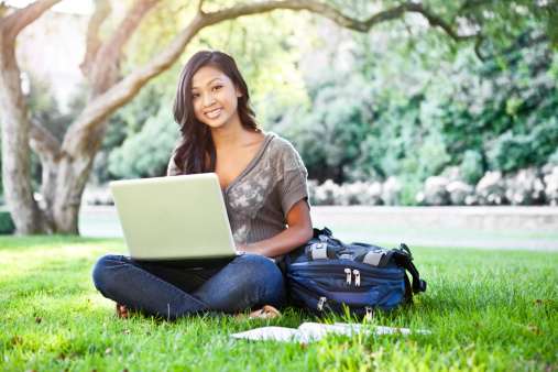 student outside on laptop