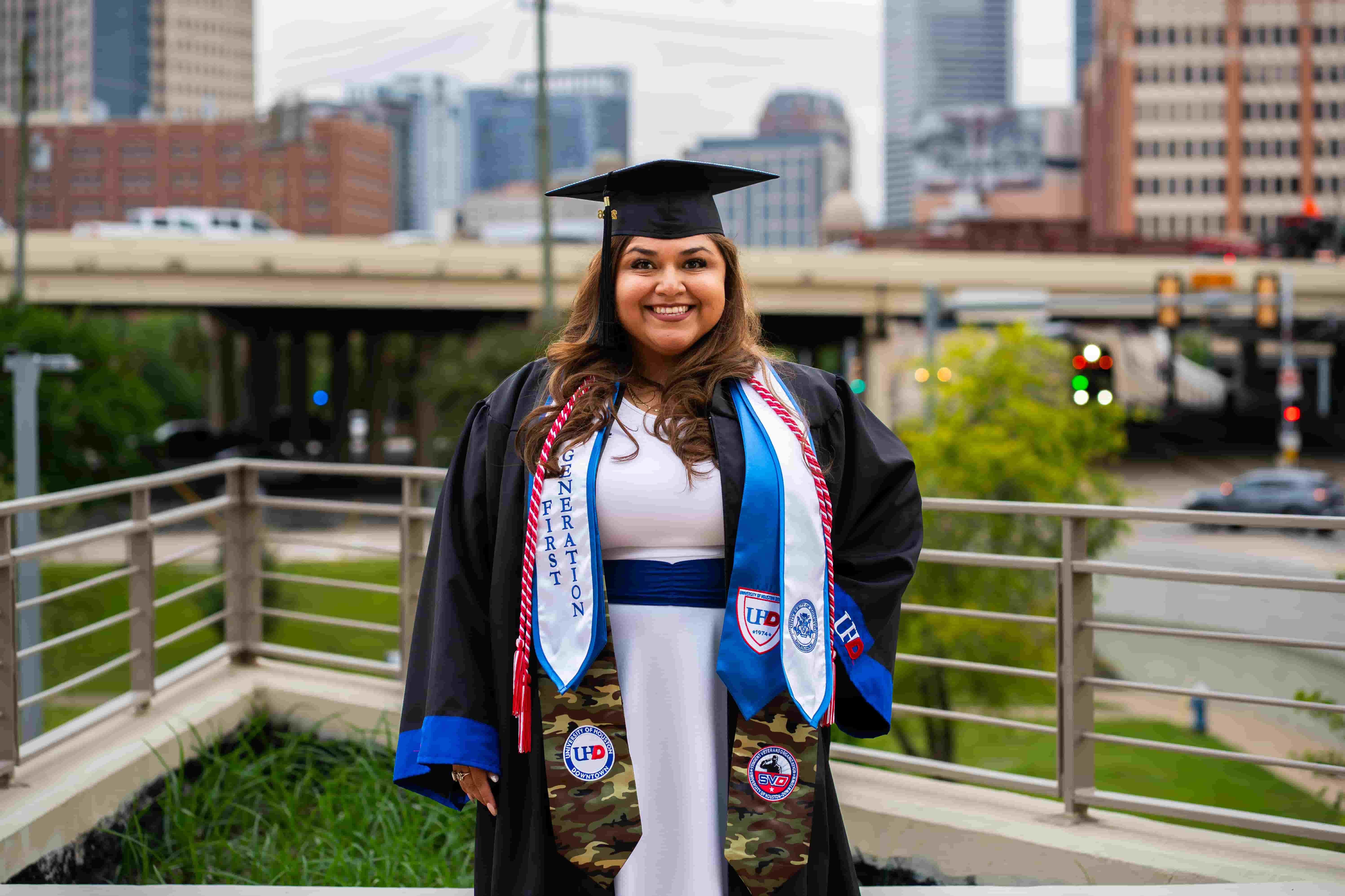 female graduate with cityscape background