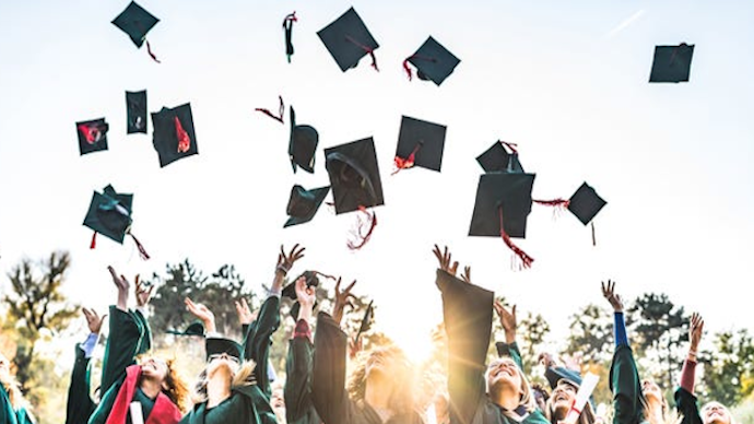 graduation caps flying up in the air