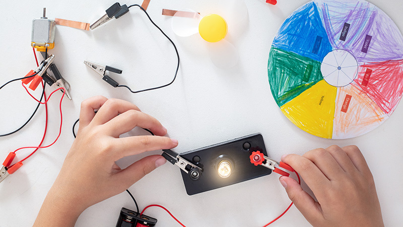 Wires completing a circuit to light a bulb