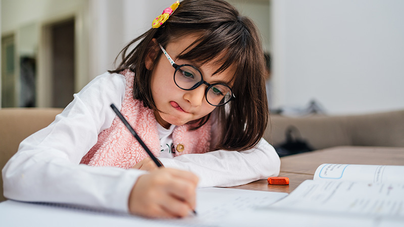 Young girl writing in a journal