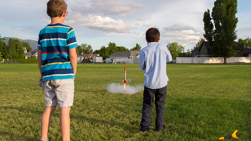 Two children launching rockets