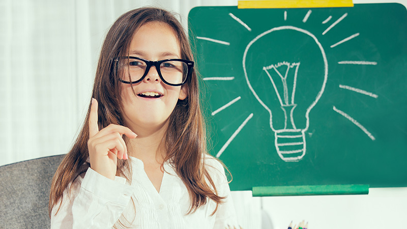 Girl wearing glasses next to a light bulb