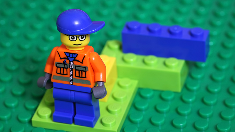 Lego man on a green background
