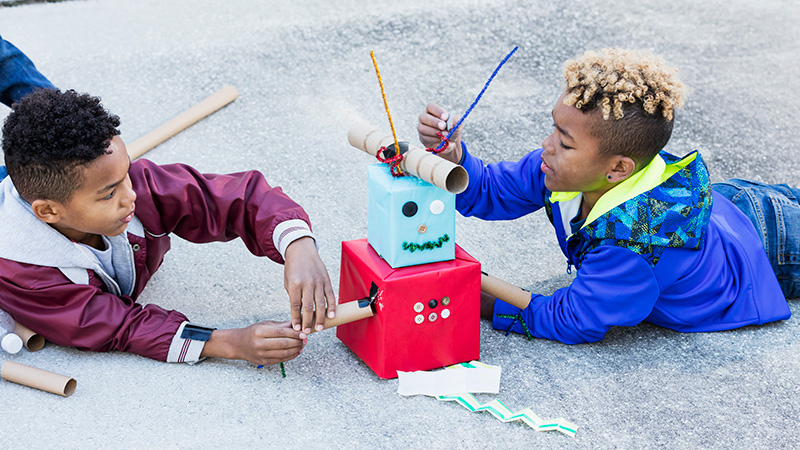 Girl in hard hat imagining building things