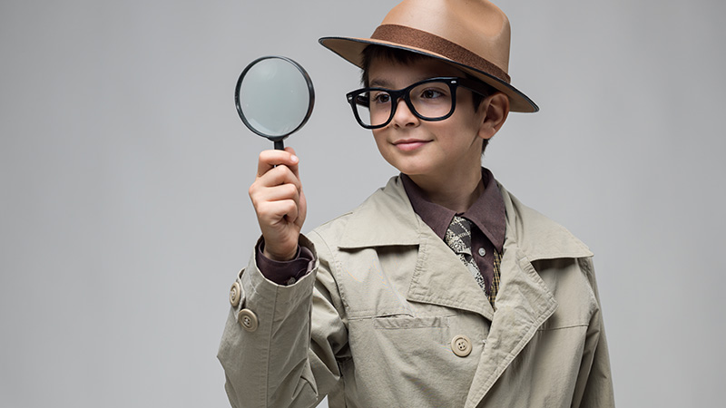 Boy wearing hat and trench coat
