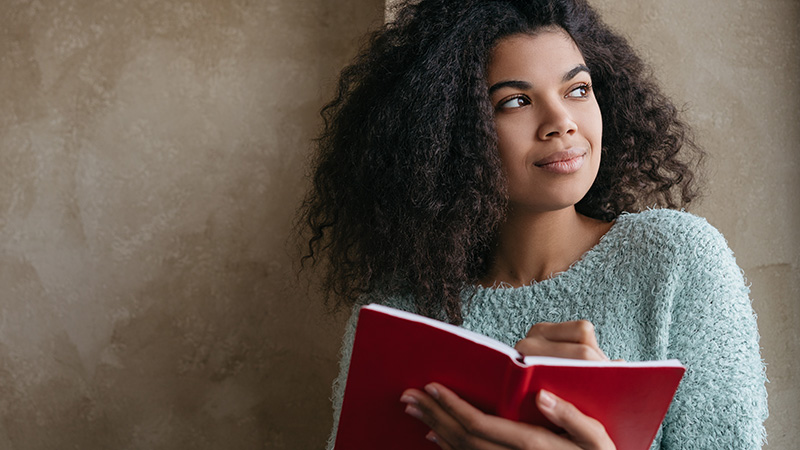Older teenager holding a journal