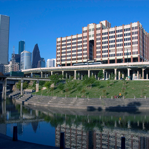 UHD main building from the east side showing Buffalo Bayou and downtown buildings in the background