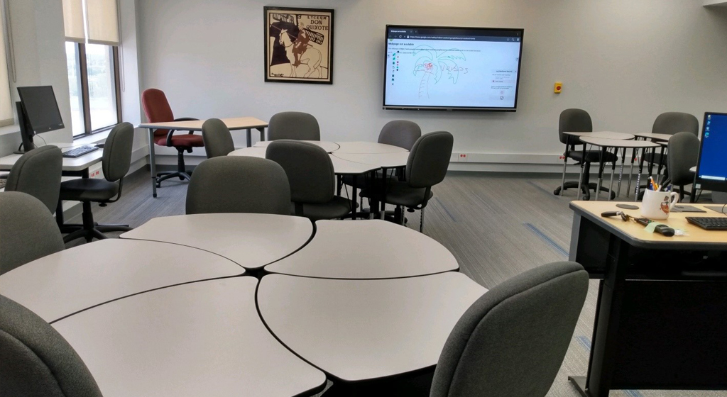 interior of the foreign language lab, tables chairs, poster or wall, television and computers