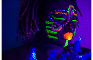 Painted face in black light by Mishayla Moss