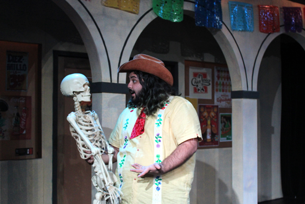 An actor talks to a skeleton