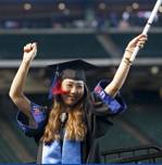 UHD female student with diploma celebrating