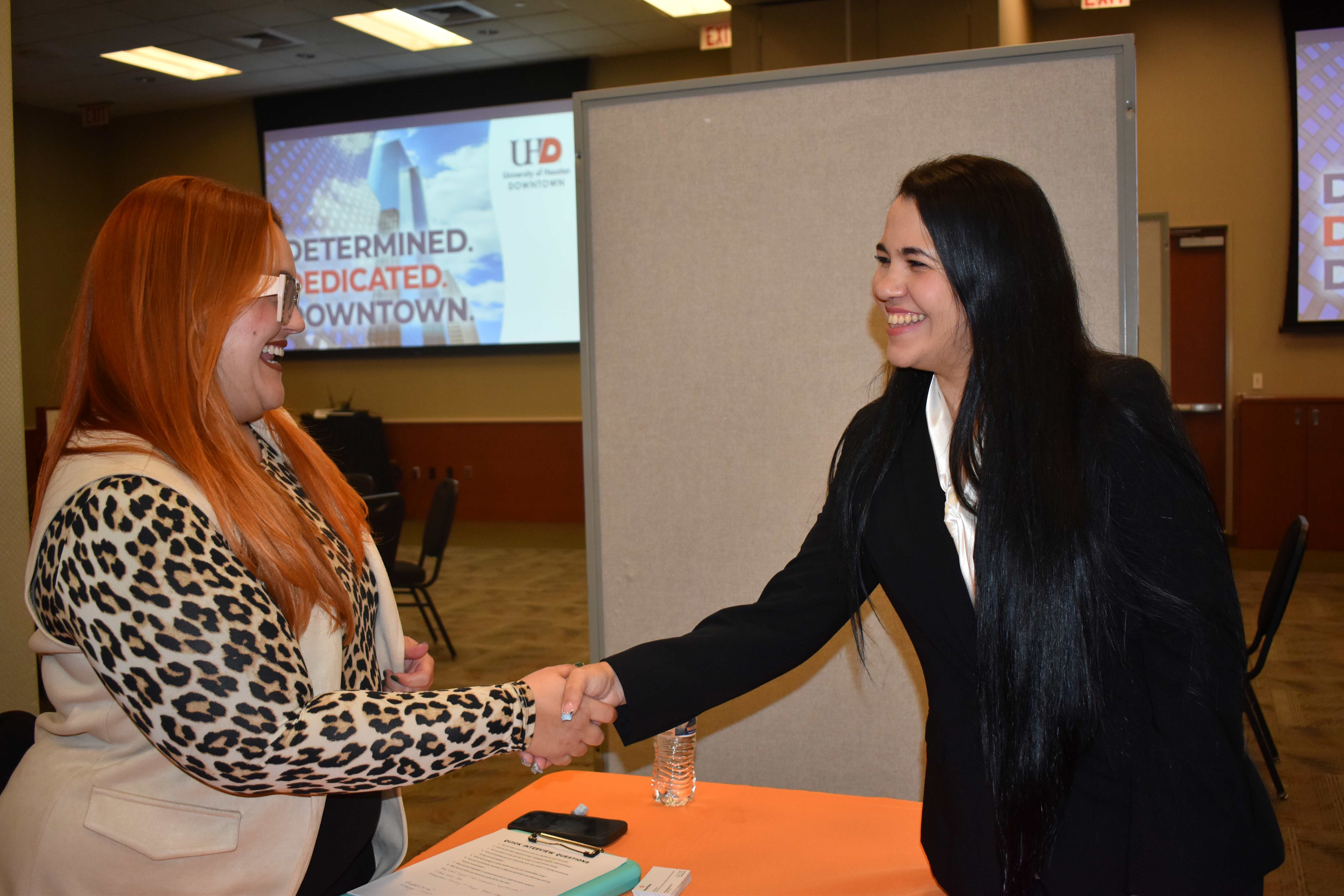 Employer shaking hands with student