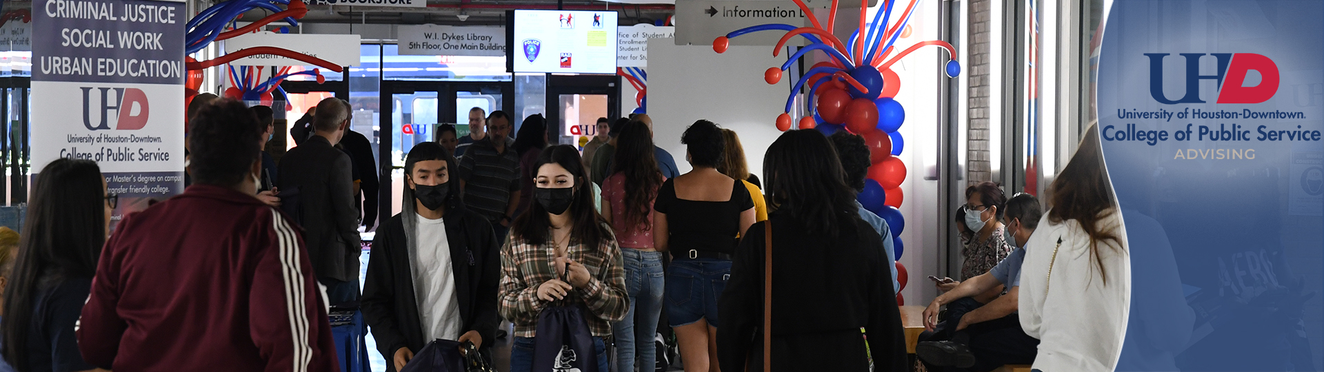 Students walking on the 3rd floor hallway at UHD main building
