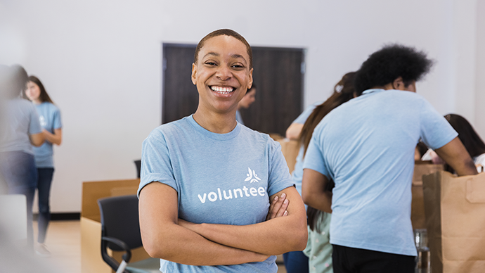 Volunteer with others smiling
