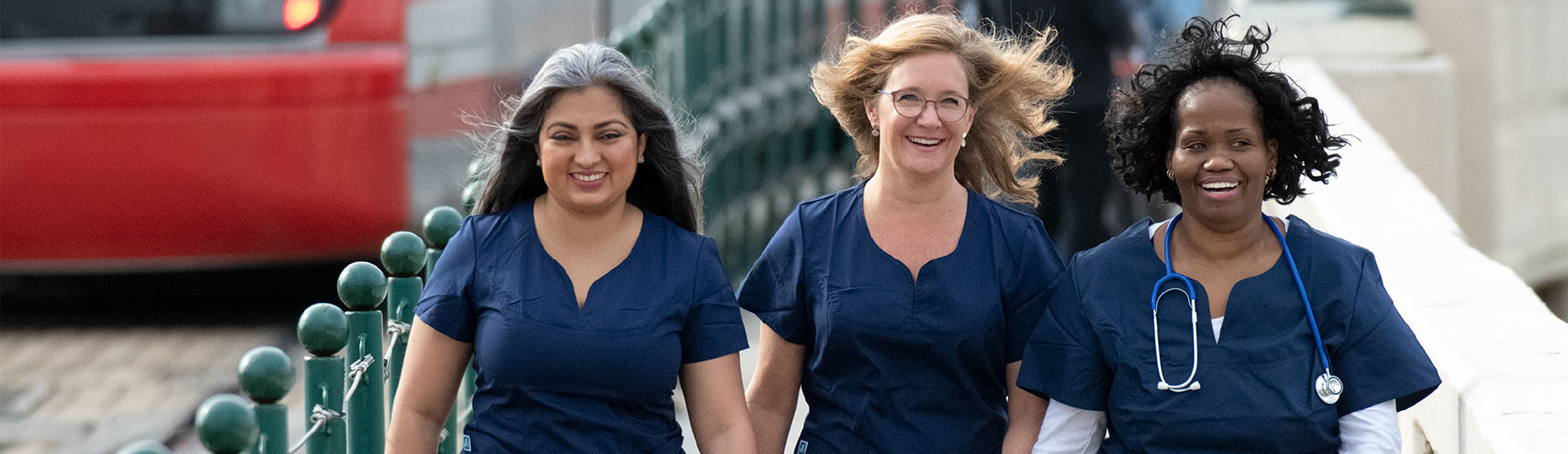 Three Women walking in scrubs