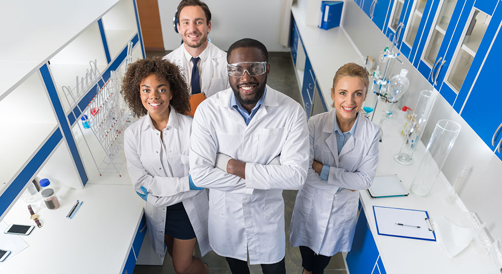 A group of lab techs smiling together.