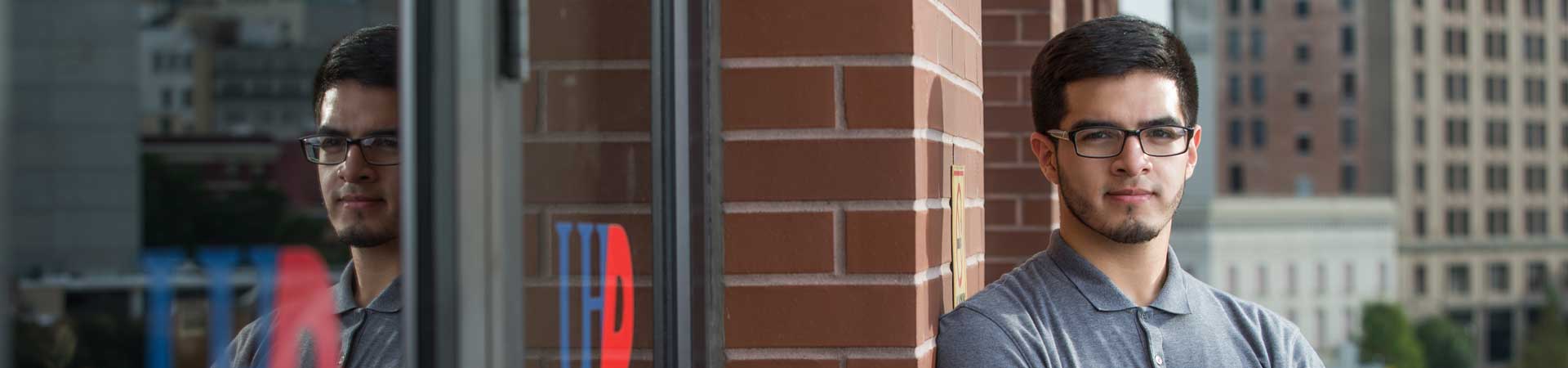 UHD student leaning by the door at UHD