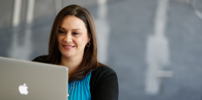 student with laptop outside