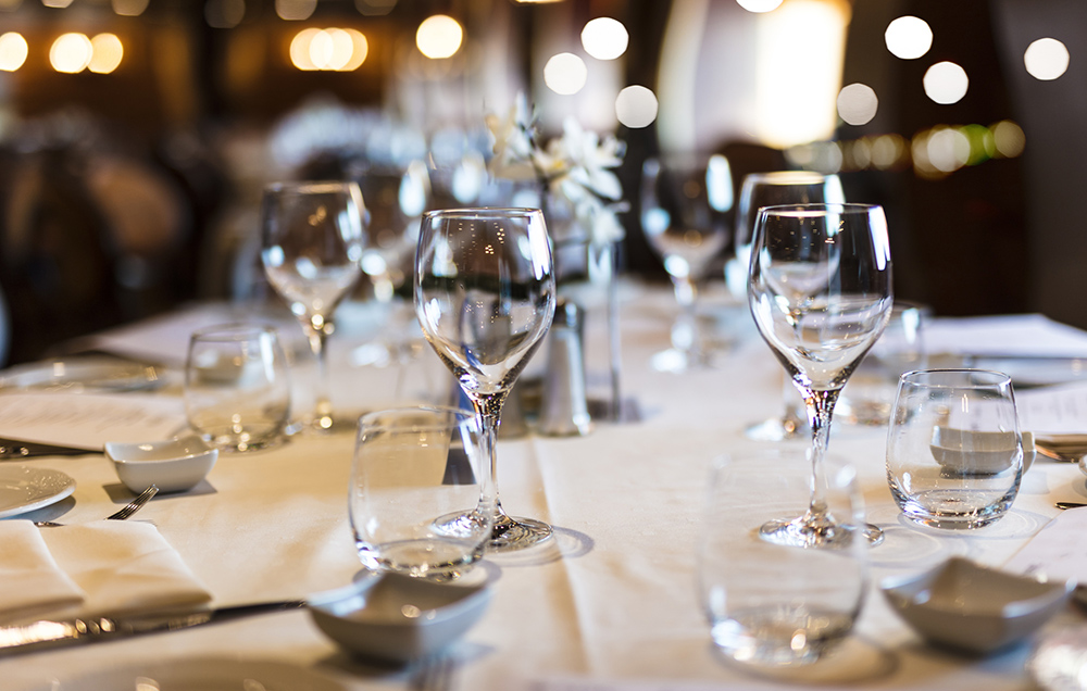 wine glasses and plates on a table