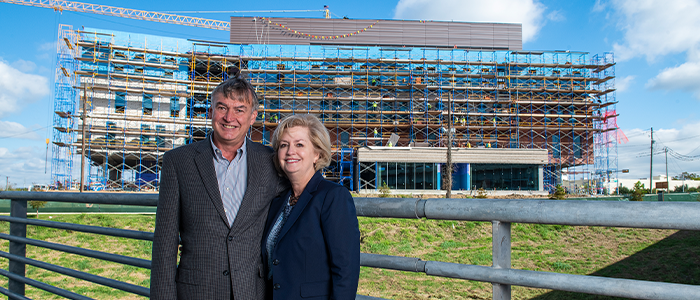 Mark and Tami Mallett in front of the Science and Technology Building Under Construction.