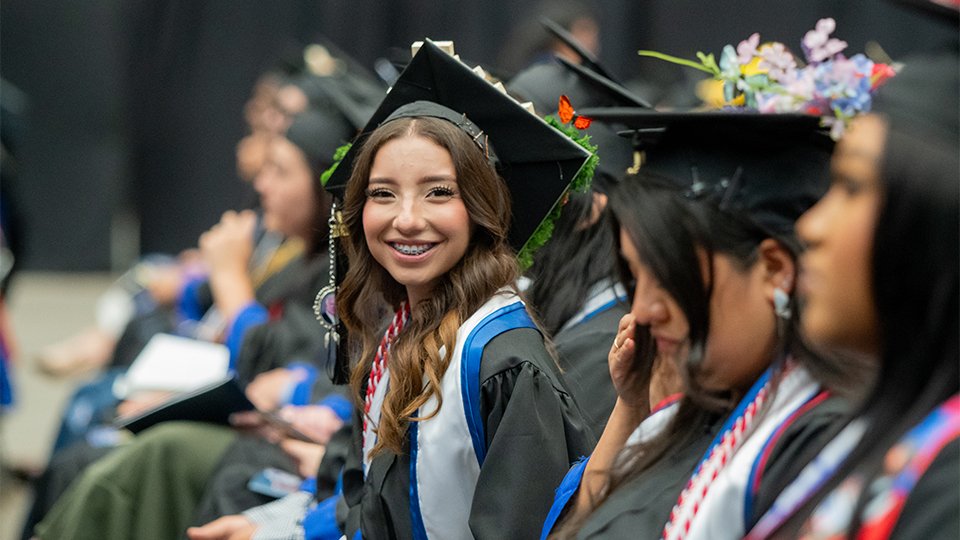 Student at Graduation smiling in regalia