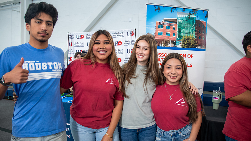 4 students smiling toward camera