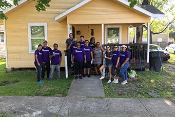 Smaller group photo in front of a house