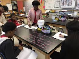 Kamaria Swan helping students in classroom
