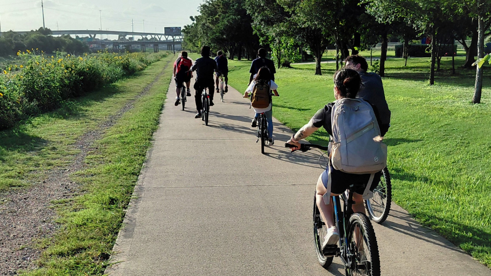 UHD student biking around Buffalo Bayou downtown