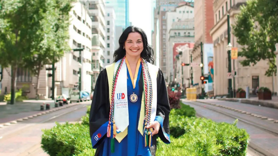Amber Perez posing in her commencement regalia