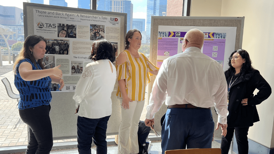 Students and Faculty reviewing student presentations
