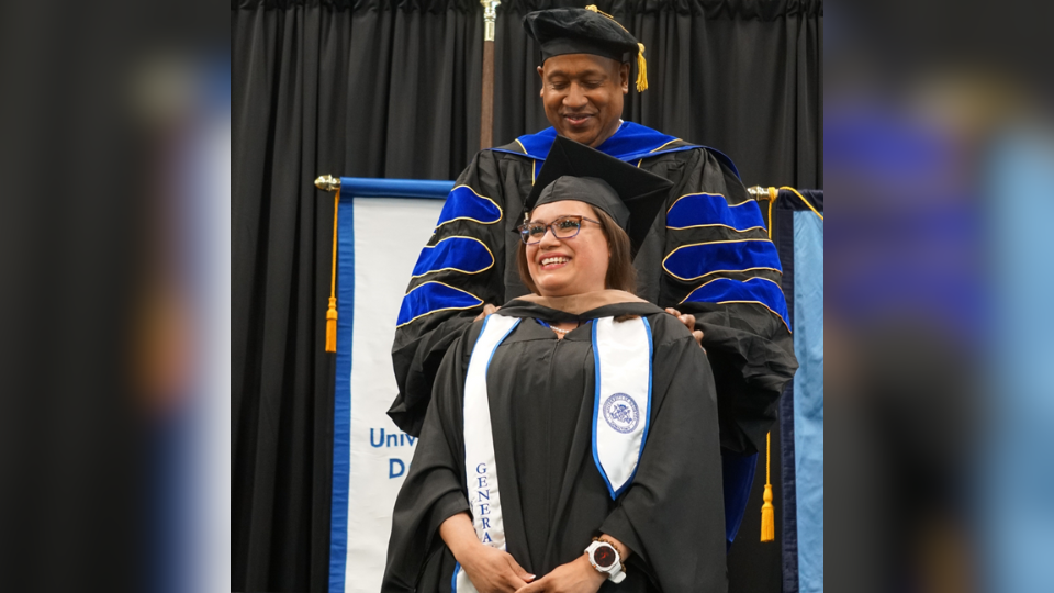 A student receiving being hooded at the hooding ceremony.
