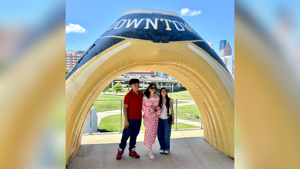 Student posing with family after receiving their UHD ring