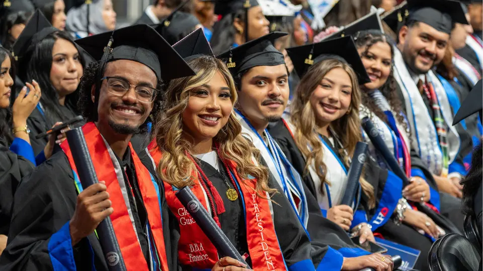 Graduates in full regalia seated during commencement
