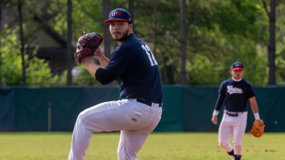Baseball pitcher winding up to throw