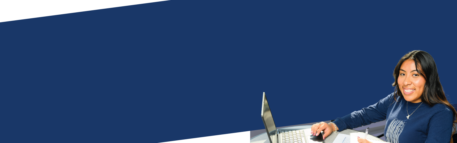 Two female students looking at class notes together