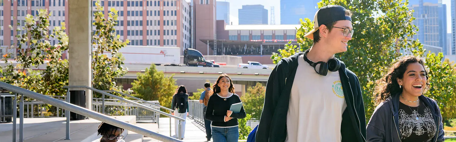 Male and female students walking outside of the College of Science and Technology