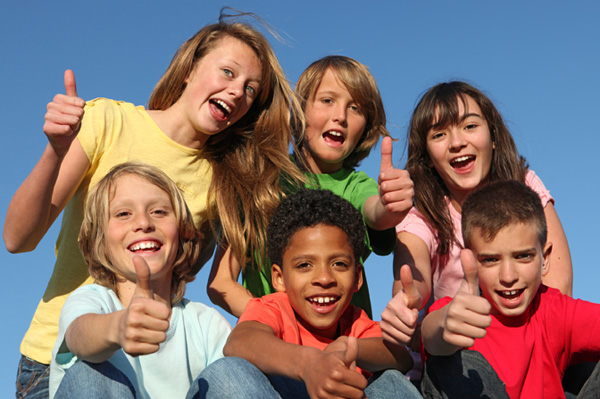 Group of kids giving a thumbs up