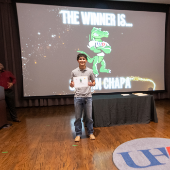 A UHD student holds a sports and fitness award