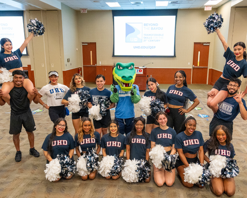 University of Houston-Downtown cheer team with university mascot edugator
