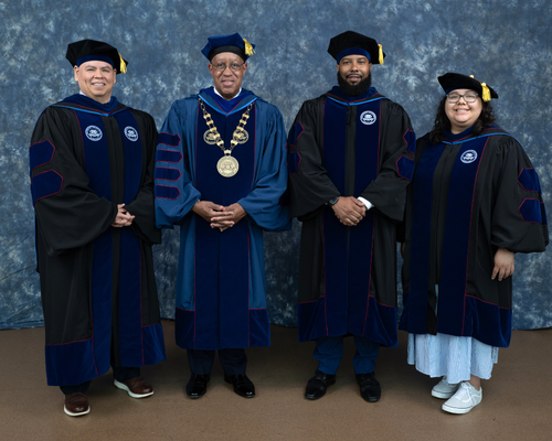 Diana Ambrosio wears graduation regalia next to former student government association president, university of houston downtown President Loren J. Blanchard, and staff council president Adrian Bermudez at the university of houston downtown's commencement ceremony 