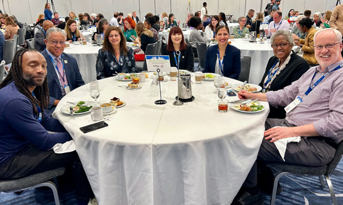President Loren Blanchard ( second from left) and Dr. Zeenat Mitha ( third from left) sharing a meal with th attendees at CUMU conference in the Fall 2024 in Minneapolis, Minnesota. 
