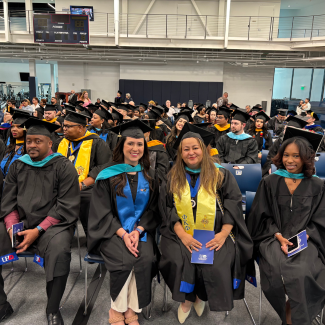 Graduates seated during the hooding ceremony.