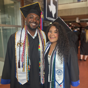 university of houston-downtown marilyn davies of college of business students smile while wearing commencement regalia 