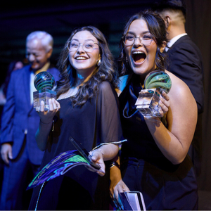 a UHD Marilyn Davies College of Business student and a University of Houston-Downtown Marilyn Davies College of Business alum hold two american marketing association crystal awards for the college's winning campaigns