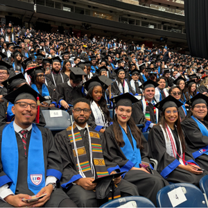 UHD students sit in an audience at commencement at NRG Stadium in Houston, Texas 