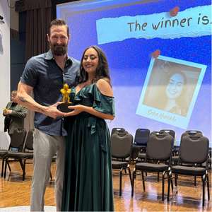 luke fedell smiles with a student in the university of houston-downtown's o'kane theatre program. The student was given an award at one main event.