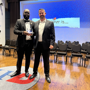 Director for Student Leadership and Involvement stands with an award-winner at the One Main Event student awards ceremony at the university of houston-downtown